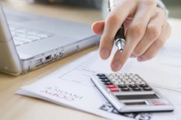 Hand using a calculator